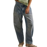 Woman wearing a green sleeveless top and blue jeans on a white background